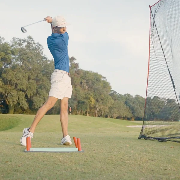 Rukket Pathfinder Impact Mat showing a golfer mid-swing for swing path practice.